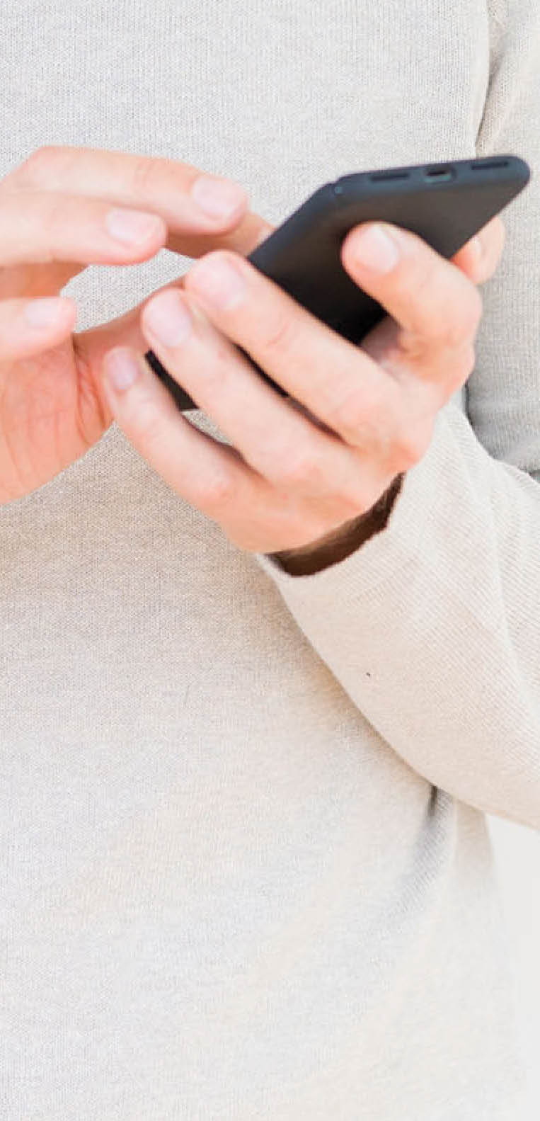 Senior man using smartphone over isolated background with a happy face standing and smiling with a confident smile showing teeth